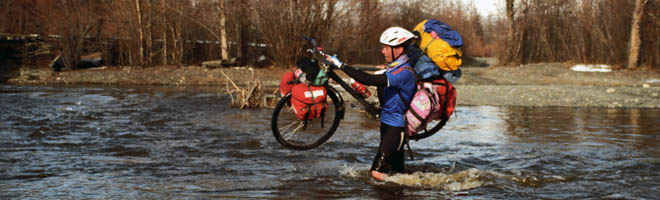 Jens Alstrup with his bike crossing a river in Kolyma, 1997